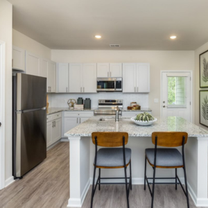 Cartersville rental home kitchen with white cabinetry and granite countertops